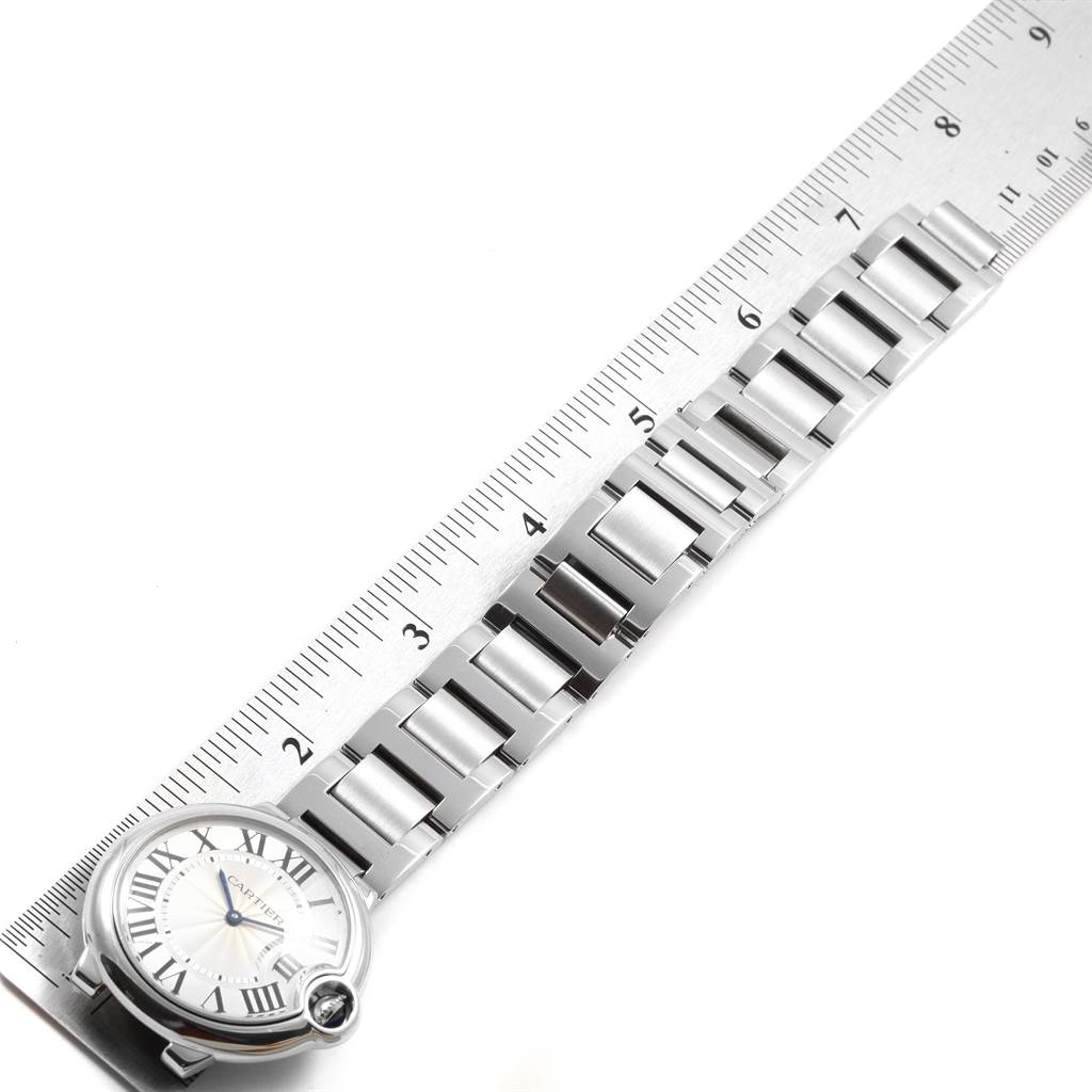 The image shows a stainless steel bracelet of the Cartier Ballon Bleu W69011Z4 Women
s Stainless Steel Silver Dial W69011Z4 Women
s Stainless Steel Silver Dial watch, laid next to a ruler for measurement.