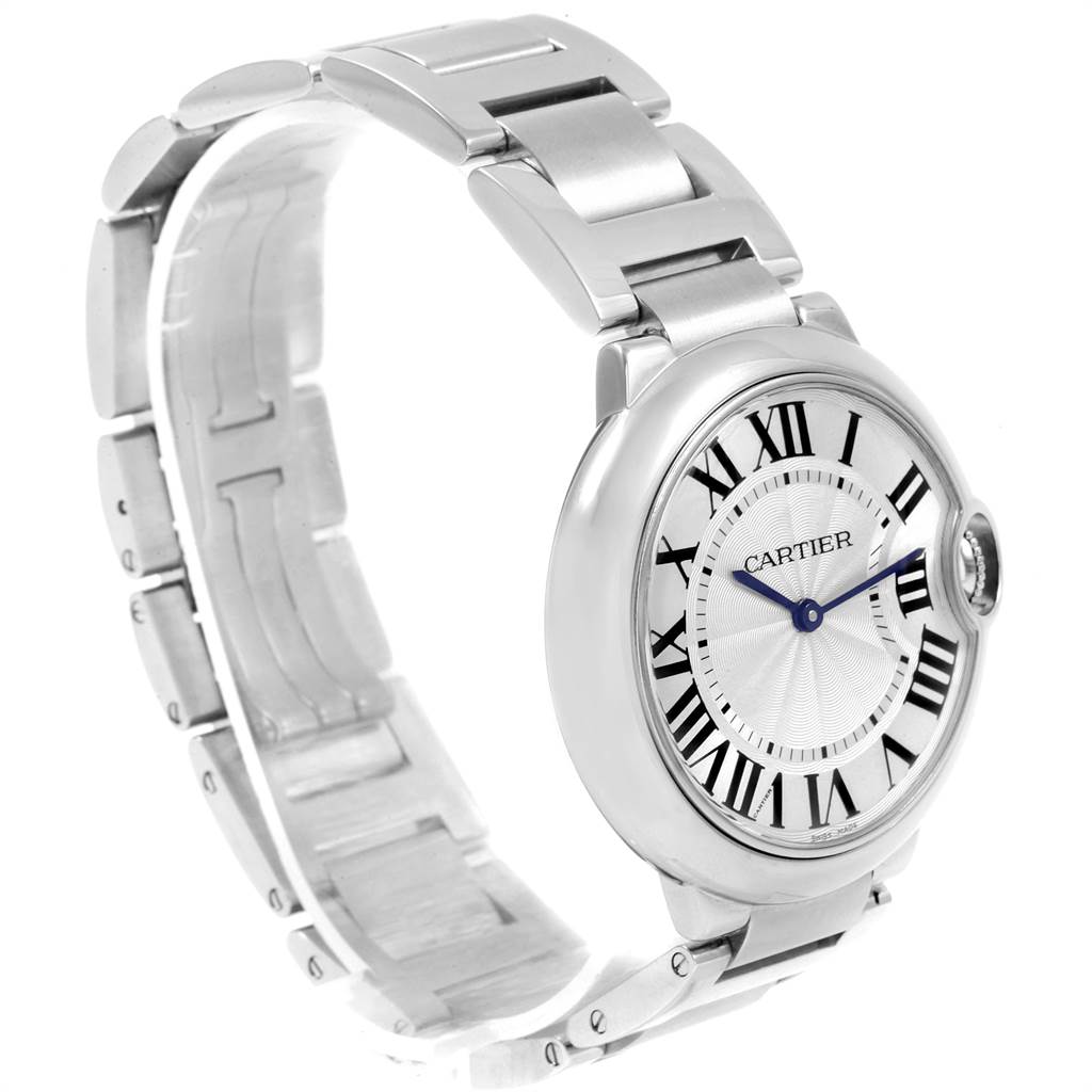The image shows a side angle view of the Ballon Bleu watch by Cartier, highlighting the dial, Roman numerals, and part of the metal bracelet.