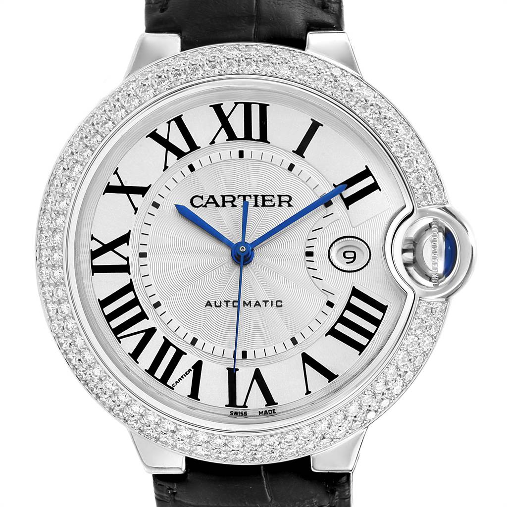 The image shows a front view of a Cartier Ballon Bleu WJBB0032 Women
s White Gold Silver Dial WJBB0032 Women
s White Gold Silver Dial watch, highlighting its Roman numerals, blue hands, date window, and diamond-studded bezel.