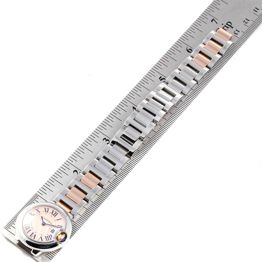 The image shows a Cartier Ballon Bleu W6920034 Women's Steel and Gold (two tone) Mother of Pearl Dial W6920034 Women's Steel and Gold (two tone) Mother of Pearl Dial watch laid flat with a ruler measuring its bracelet length.