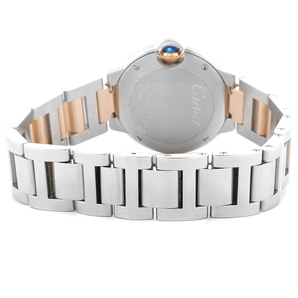 The image shows the back view of a Ballon Bleu model by Cartier, highlighting its metal bracelet and caseback.