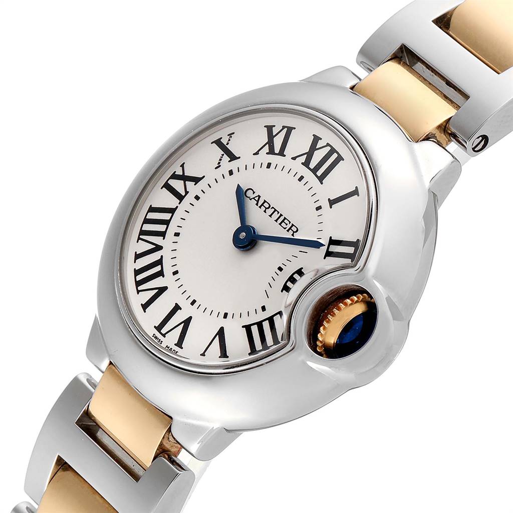 The image shows a close-up of the dial, crown, and part of the bracelet of the Ballon Bleu de Cartier watch.