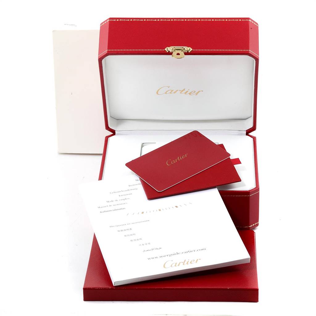 The image shows the packaging, warranty card, and manuals for the Ballon Bleu model by Cartier.