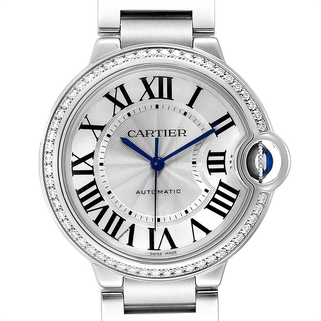 The image shows a close-up of the face of a Ballon Bleu model by Cartier, highlighting its Roman numerals, blue hands, and diamond-set bezel.