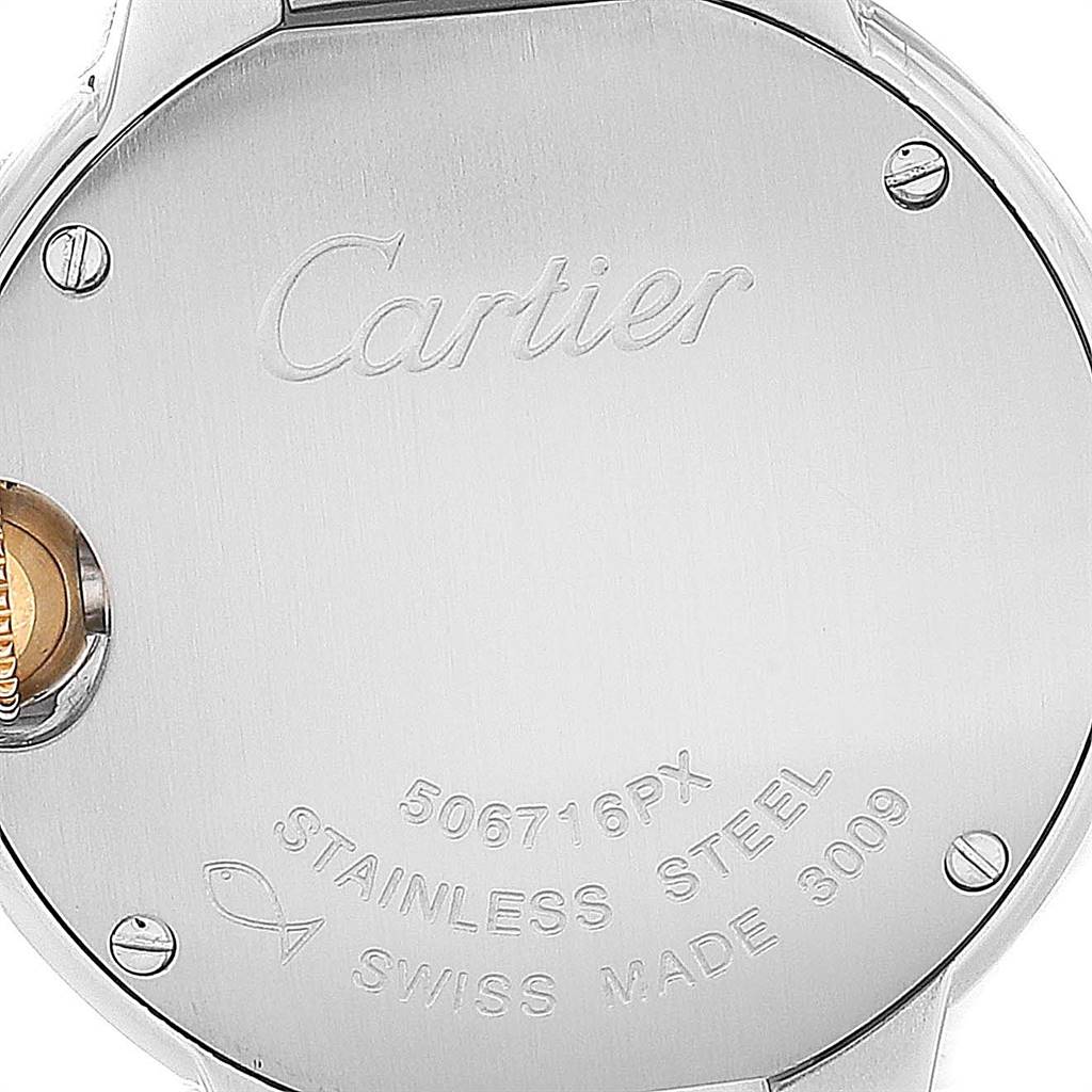The image shows the back case of the Ballon Bleu model watch by Cartier, highlighting the engravings and screws.