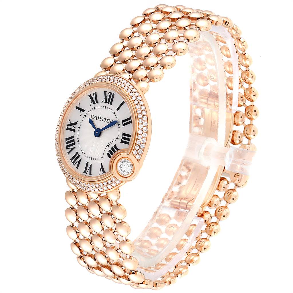 The image shows a Cartier Ballon Bleu watch with a side angle, highlighting its face, bezel, and gold link bracelet.