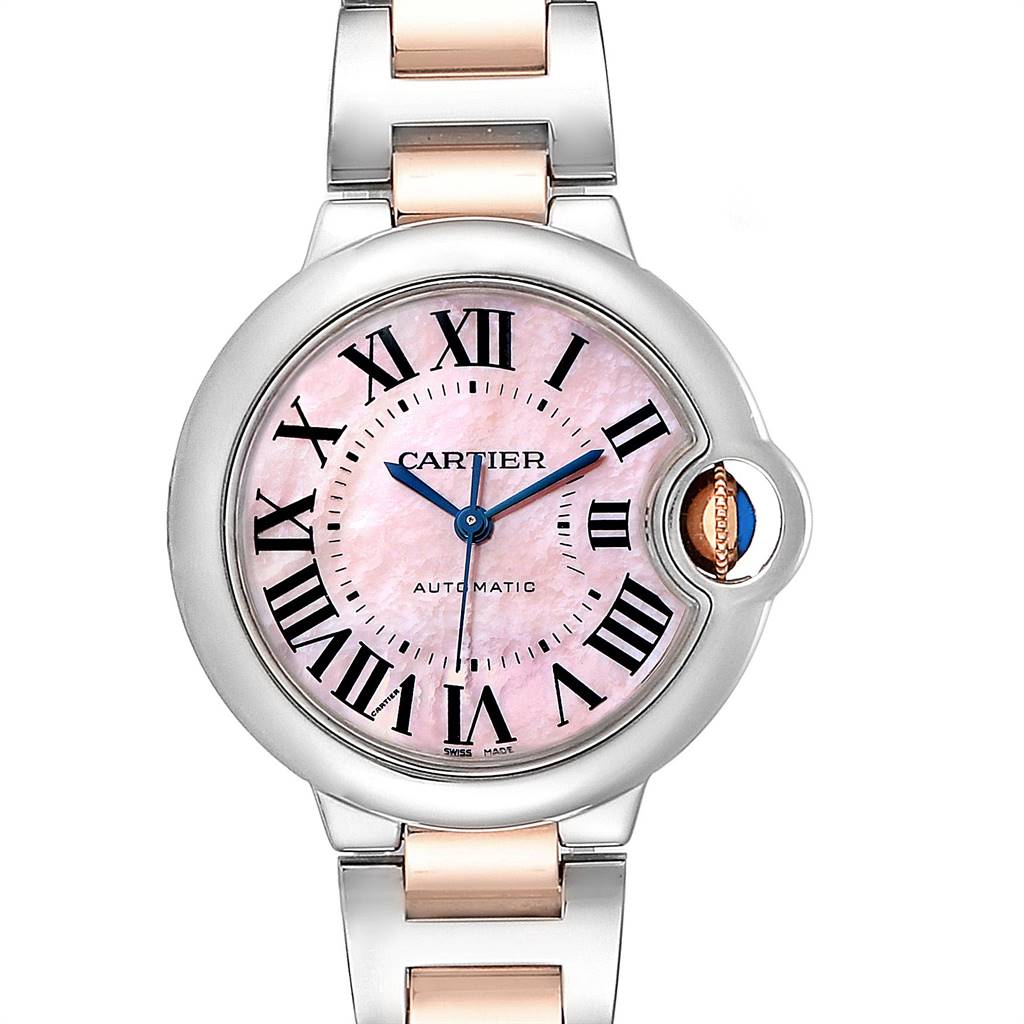 This image shows a front view of a Cartier Ballon Bleu W6920098 Women
s Steel and Gold (two tone) Mother of Pearl Dial W6920098 Women
s Steel and Gold (two tone) Mother of Pearl Dial watch with a pink dial and a silver and rose gold bracelet.
