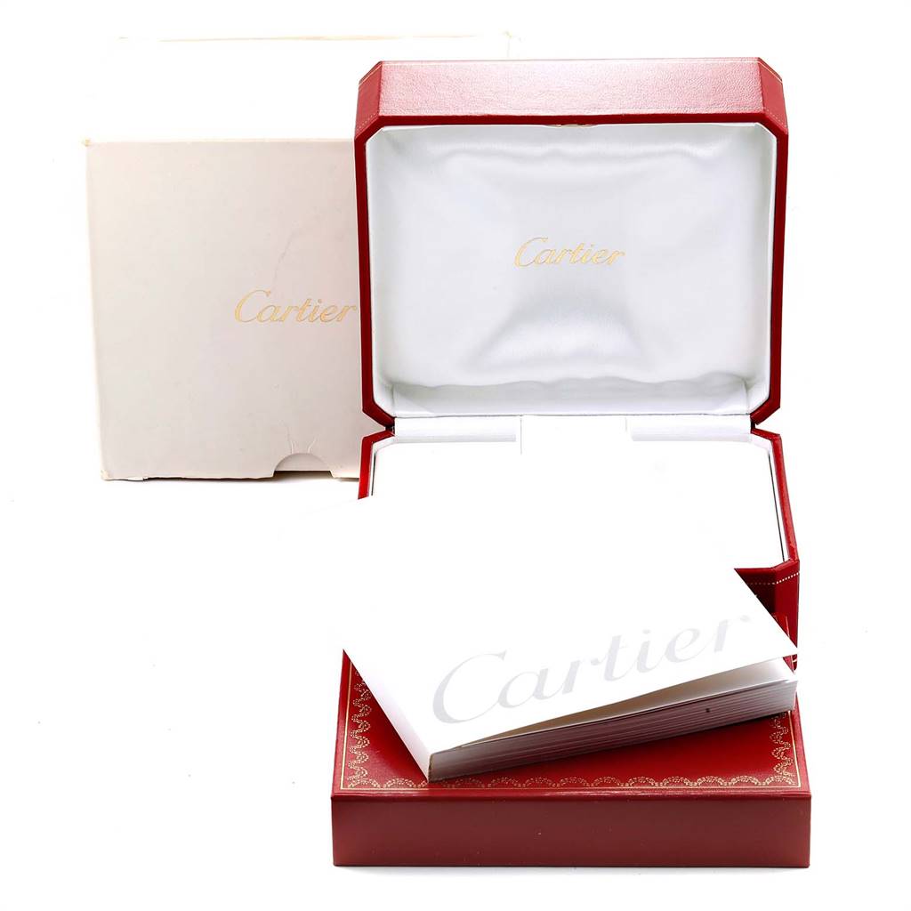 The image shows the open red watch box with a white interior and the user manual for a Ballon Bleu model by Cartier.