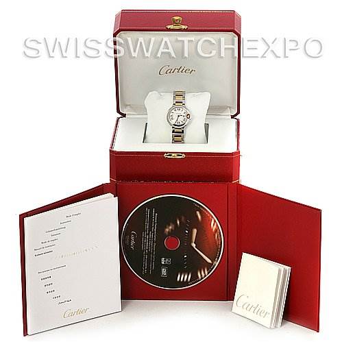 The image shows a Cartier watch in its red display box, accompanied by a booklet, a CD, and documentation.