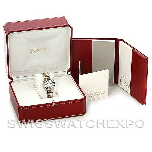 The image shows a Ballon Bleu model by Cartier, presented at an angle that reveals the watch inside a red box with accompanying manuals.
