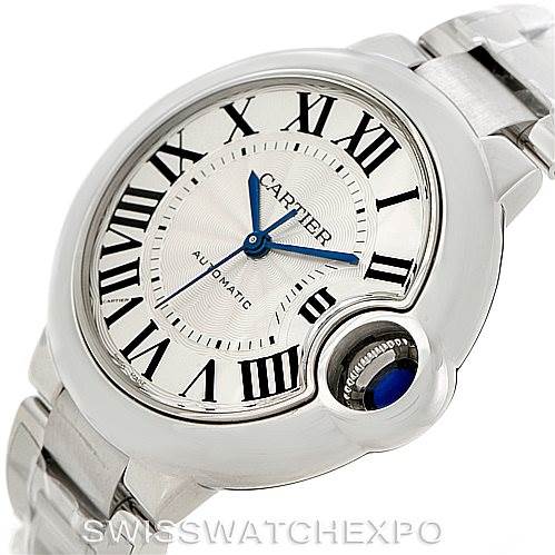 The image shows a close-up of the dial and bracelet of a Cartier Ballon Bleu W6920071 Women's Stainless Steel Silver Dial W6920071 Women's Stainless Steel Silver Dial watch, highlighting its Roman numerals and blue crown.