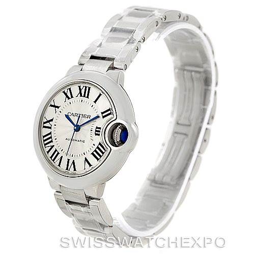 The image shows a Cartier Ballon Bleu W6920071 Women's Stainless Steel Silver Dial W6920071 Women's Stainless Steel Silver Dial watch from an oblique angle, highlighting its face, stainless steel bracelet, and blue jewel crown.