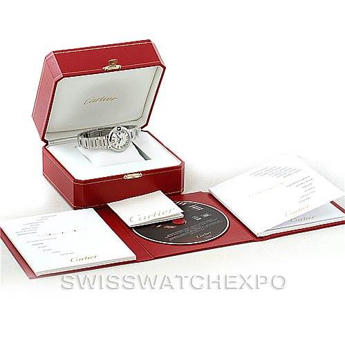 The image shows a Cartier Ballon Bleu W6920071 Women's Stainless Steel Silver Dial W6920071 Women's Stainless Steel Silver Dial watch in its open case with accompanying booklets and a CD displayed in front.
