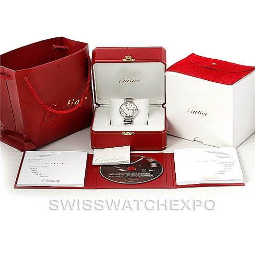 The image shows a Cartier Ballon Bleu W69011Z4 Women
s Stainless Steel Silver Dial W69011Z4 Women
s Stainless Steel Silver Dial watch in its box, surrounded by a red Cartier bag, white exterior box, and various accessories and documents.