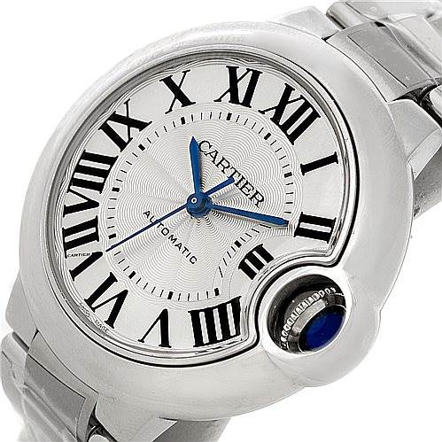 The image shows a close-up of the dial and part of the bracelet of a Ballon Bleu model by Cartier, displaying Roman numerals and blue hands.