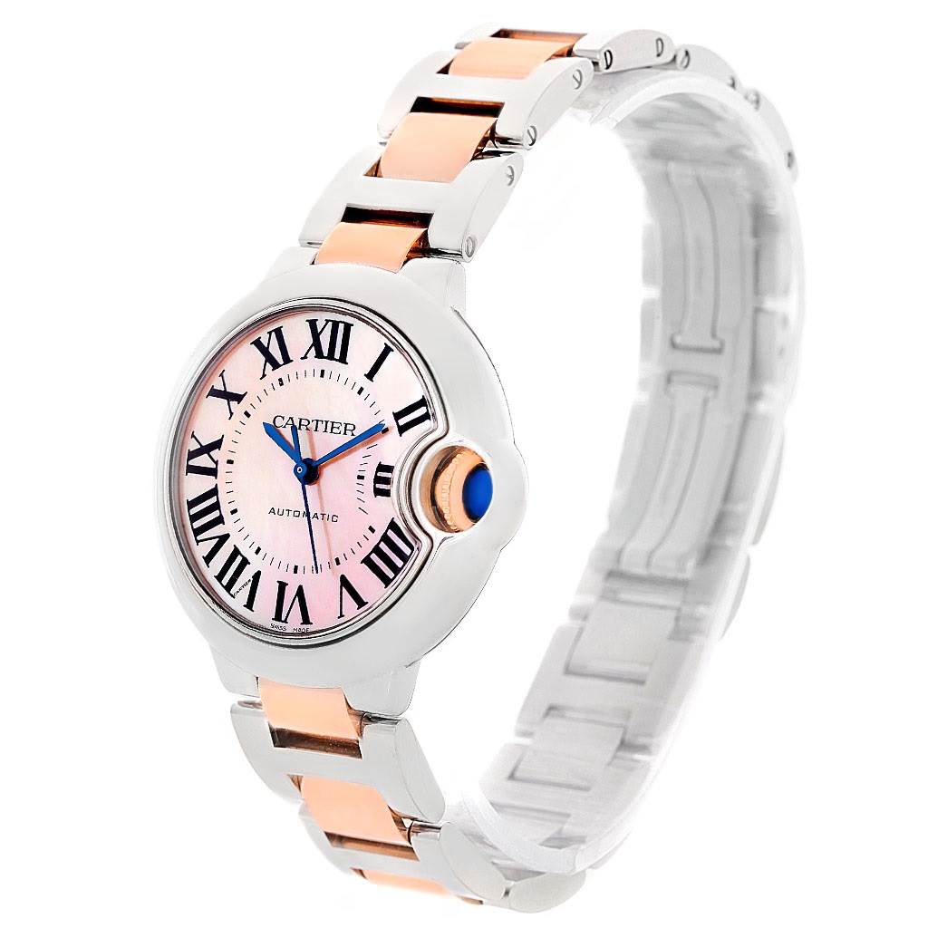 The image shows the Cartier Ballon Bleu W6920070 Women's Steel and Gold (two tone) Mother of Pearl Dial W6920070 Women's Steel and Gold (two tone) Mother of Pearl Dial watch at a three-quarter angle, highlighting the face, crown, and two-tone bracelet.