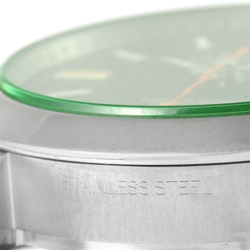 The image shows a close-up of the edge and side inscription of a stainless steel Rolex Milgauss 116400V Men
s Stainless Steel Black Dial 116400V Men
s Stainless Steel Black Dial watch, highlighting the green-tinted glass.