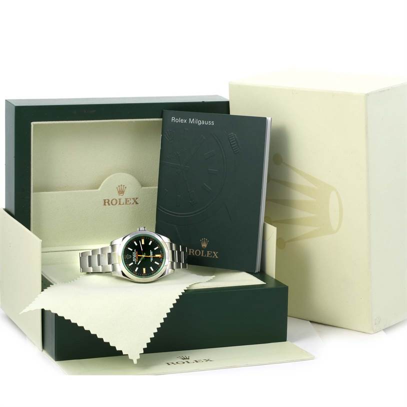 The image shows a Rolex Milgauss 116400V Men
s Stainless Steel Black Dial 116400V Men
s Stainless Steel Black Dial watch from a front angle, along with its box, manual, and cleaning cloth.