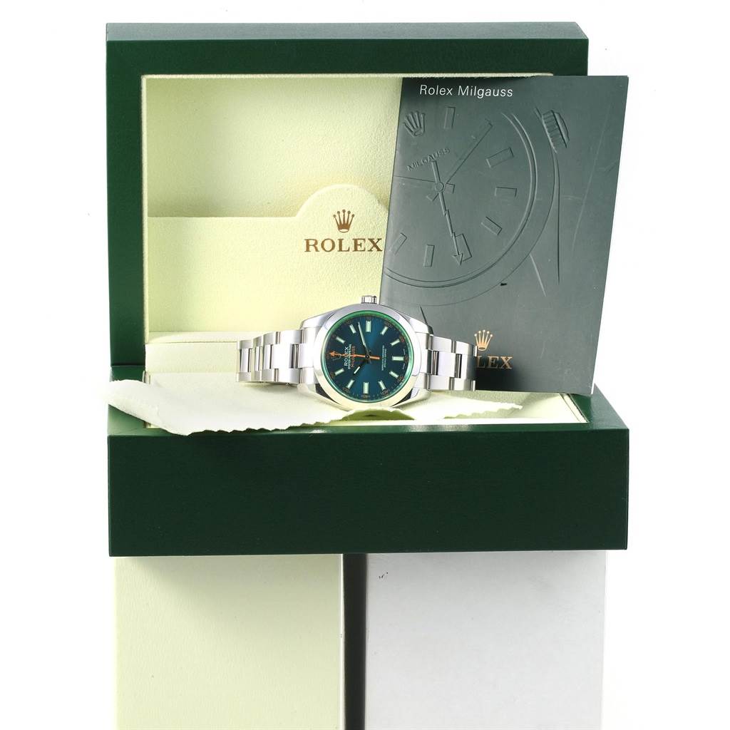The Rolex Milgauss 116400GV Men's Stainless Steel Blue Dial 116400GV Men's Stainless Steel Blue Dial watch is shown inside its box with a booklet on the side, viewed from the front.