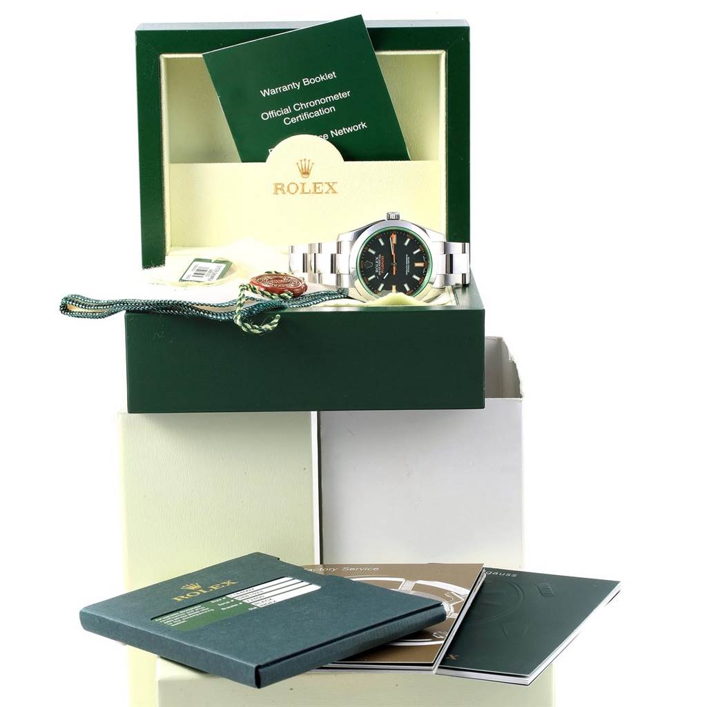 The image shows a Rolex Milgauss 116400V Men's Stainless Steel Black Dial 116400V Men's Stainless Steel Black Dial watch in its open box with booklets and tags.