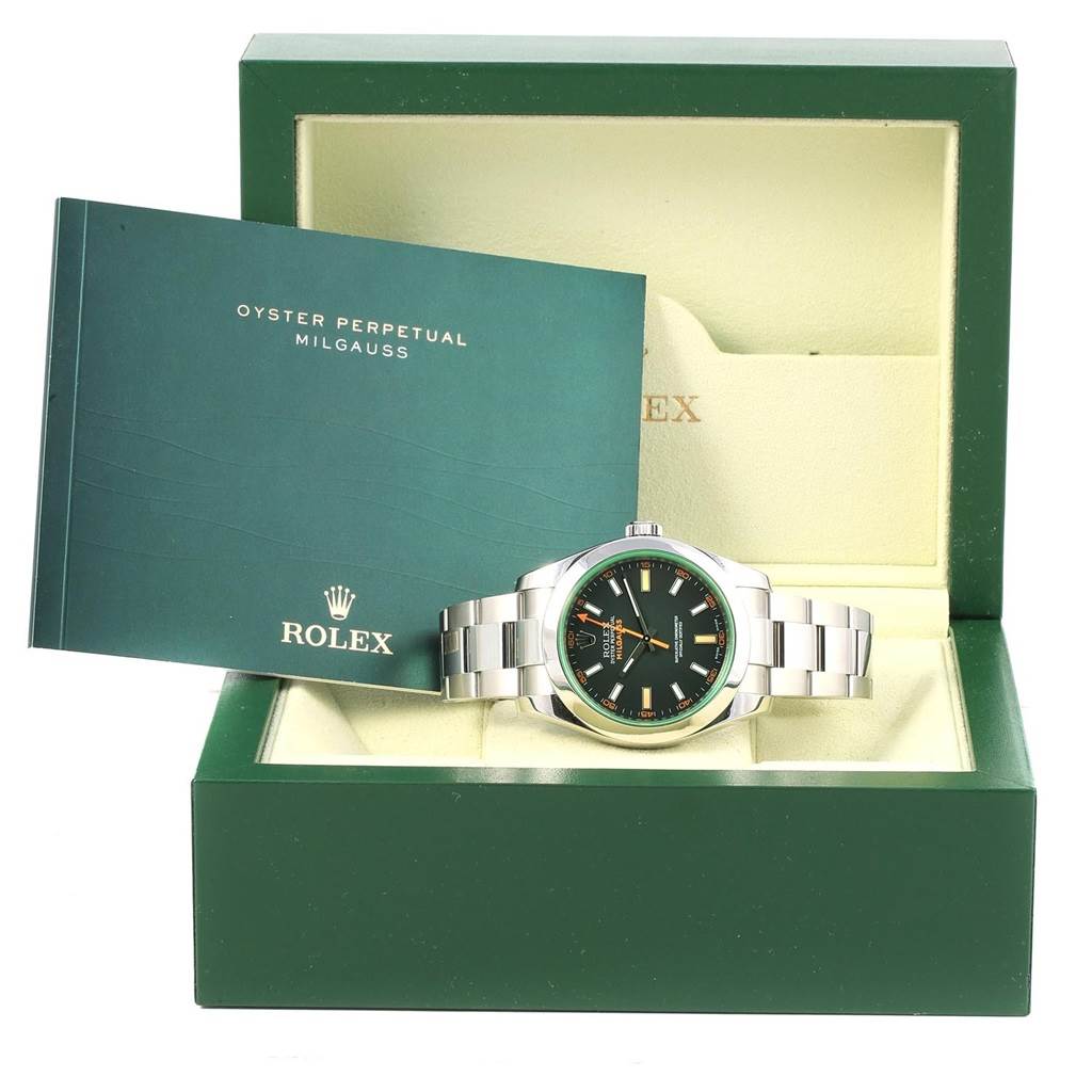 The image shows a Rolex Milgauss 116400V Men's Stainless Steel Black Dial 116400V Men's Stainless Steel Black Dial watch placed in its open box, alongside a manual tilted inside the box.