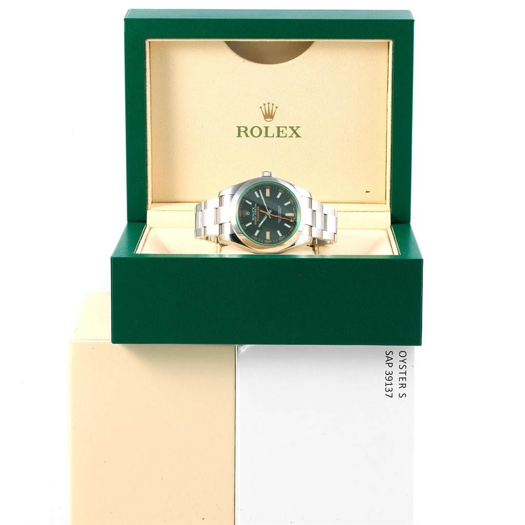 The Rolex Milgauss 116400V Men's Stainless Steel Black Dial 116400V Men's Stainless Steel Black Dial watch is shown front-facing, nestled in its green and cream display box.