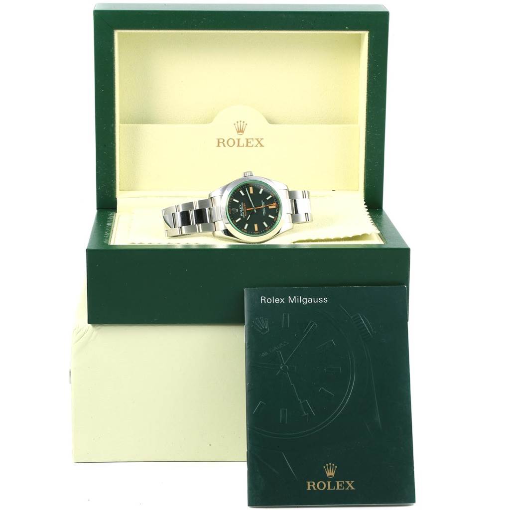 This image shows the Rolex Milgauss 116400V Men's Stainless Steel Black Dial 116400V Men's Stainless Steel Black Dial watch in its open box along with an instruction manual in front.