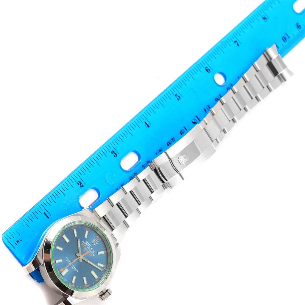 The Rolex Milgauss 116400GV Men's Stainless Steel Blue Dial 116400GV Men's Stainless Steel Blue Dial watch is shown from a top-down angle, with focus on the face and bracelet alongside a measuring ruler.