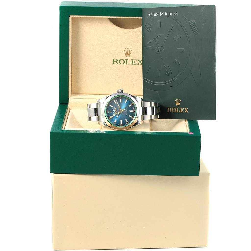 The image shows a Rolex Milgauss 116400GV Men's Stainless Steel Blue Dial 116400GV Men's Stainless Steel Blue Dial watch displayed in an open green and beige box with its instruction manual.