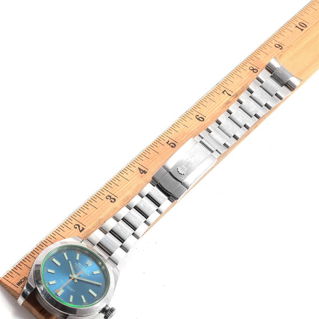 The image shows a Rolex Milgauss 116400GV Men's Stainless Steel Blue Dial 116400GV Men's Stainless Steel Blue Dial watch laid flat next to a ruler, displaying the face, case, and metal bracelet.