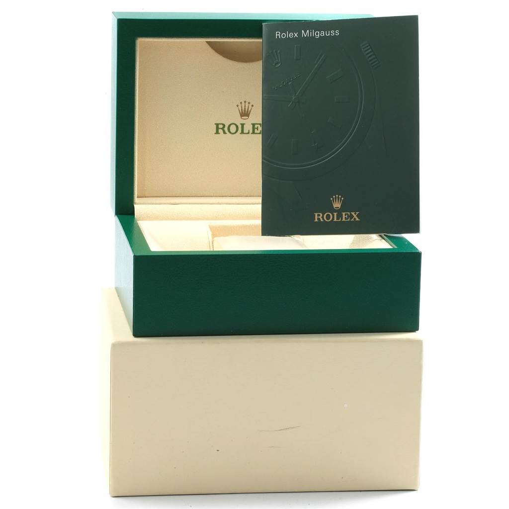 The image shows an open Rolex Milgauss 116400GV Men's Stainless Steel Blue Dial 116400GV Men's Stainless Steel Blue Dial watch box with a Rolex booklet partially covering the box.