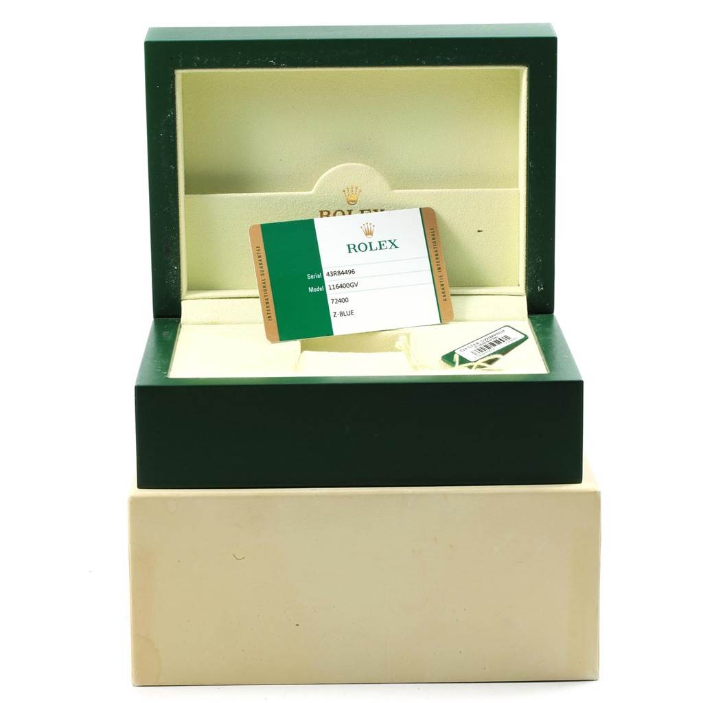 The image shows a green Rolex box containing the warranty card for a Rolex Milgauss 116400GV Men's Stainless Steel Blue Dial 116400GV Men's Stainless Steel Blue Dial model watch.