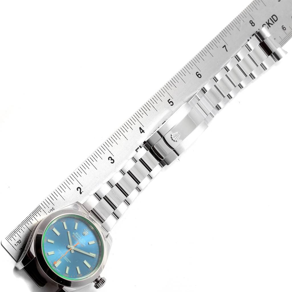 The image shows a top-down view of a Rolex Milgauss 116400GV Men's Stainless Steel Blue Dial 116400GV Men's Stainless Steel Blue Dial watch with its full metal bracelet extended and a ruler measuring its length.