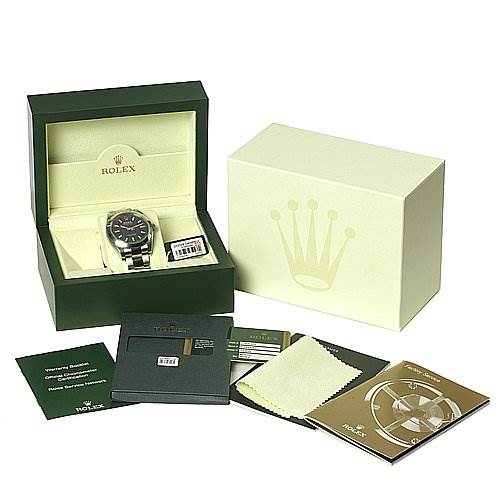 The image shows a Rolex Milgauss 116400V Men's Stainless Steel Black Dial 116400V Men's Stainless Steel Black Dial watch placed in its open box, surrounded by its packaging, manuals, and cleaning cloth from a front angle.