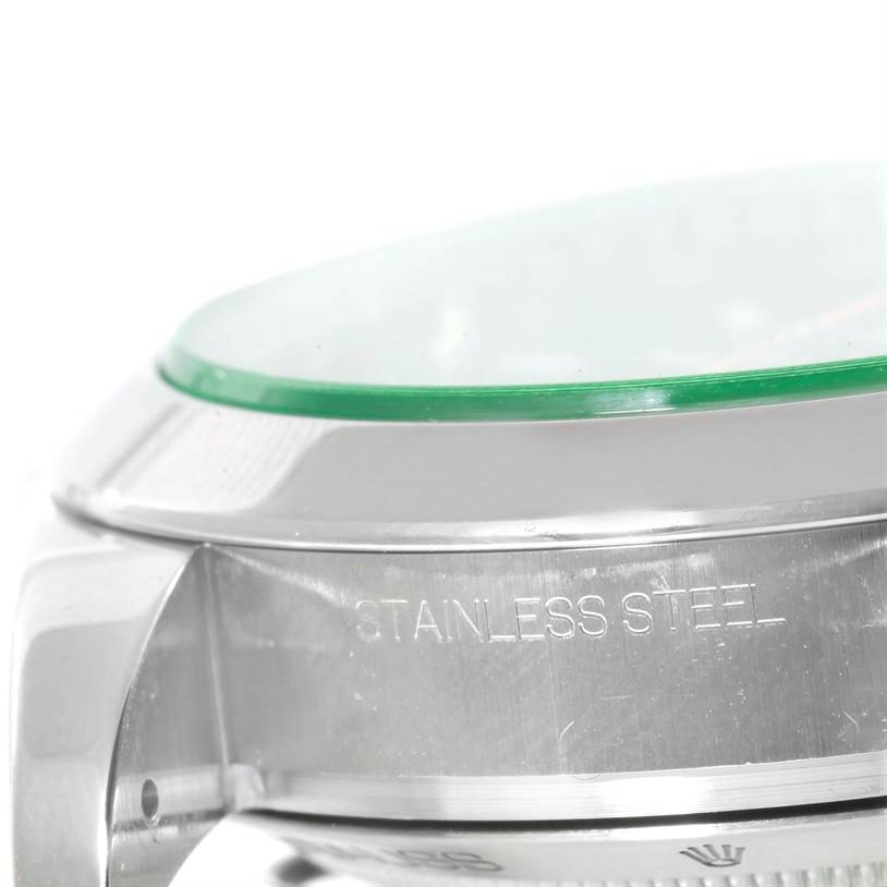 The image shows a close-up of the stainless steel case and green sapphire crystal of the Rolex Milgauss 116400V Men's Stainless Steel Black Dial 116400V Men's Stainless Steel Black Dial watch.