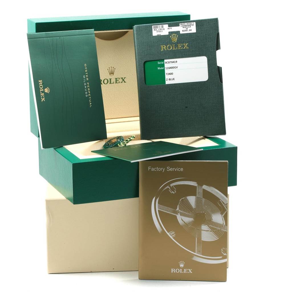 The image shows an angled view of a Rolex Milgauss 116400GV Men's Stainless Steel Blue Dial 116400GV Men's Stainless Steel Blue Dial watch box, manuals, and accessories, including the warranty card and factory service booklet.