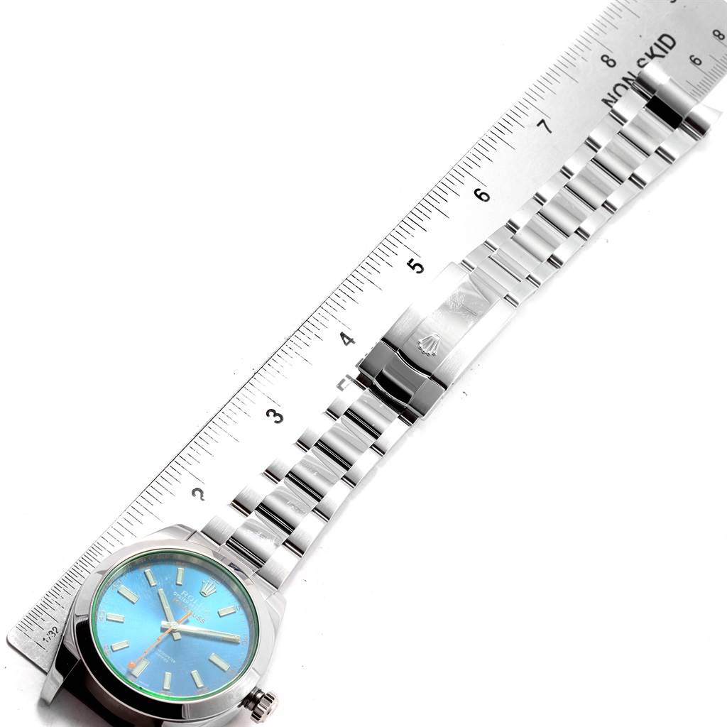 The Rolex Milgauss 116400GV Men's Stainless Steel Blue Dial 116400GV Men's Stainless Steel Blue Dial watch is shown at a top-down angle, displaying the face, bracelet, and clasp with a ruler for scale.