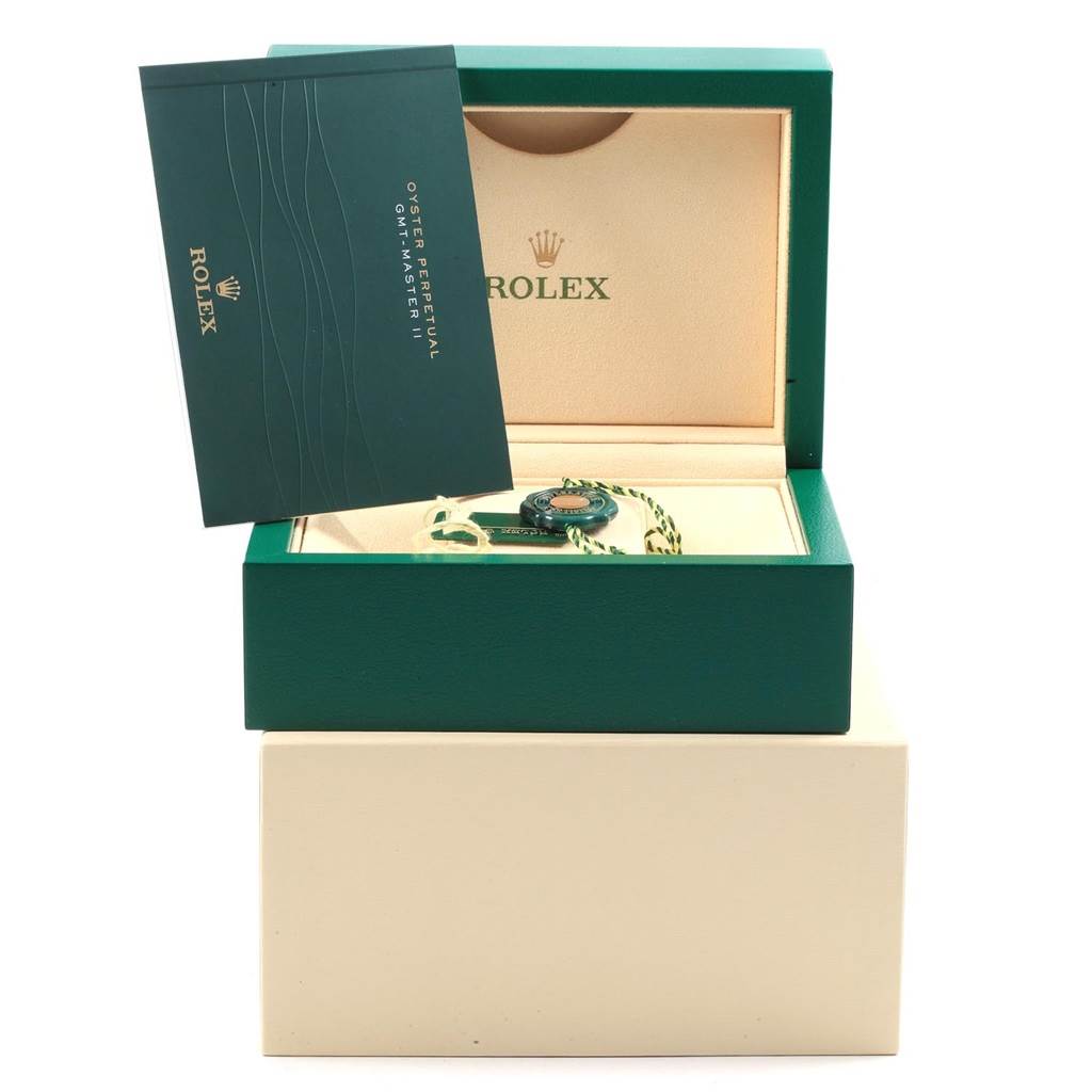 The image shows the packaging of a Rolex Milgauss 116400V Men's Stainless Steel Black Dial 116400V Men's Stainless Steel Black Dial watch, including the green box, warranty card, and accessories from a frontal angle.