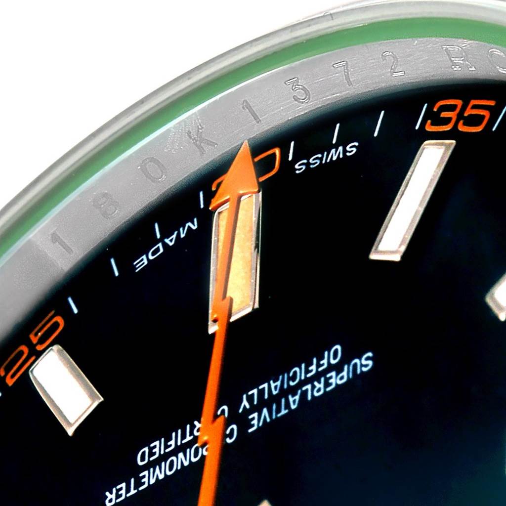 Close-up of the dial of a Rolex Milgauss 116400V Men's Stainless Steel Black Dial 116400V Men's Stainless Steel Black Dial watch, showing the orange lightning bolt second hand, hour markers, and part of the chapter ring.