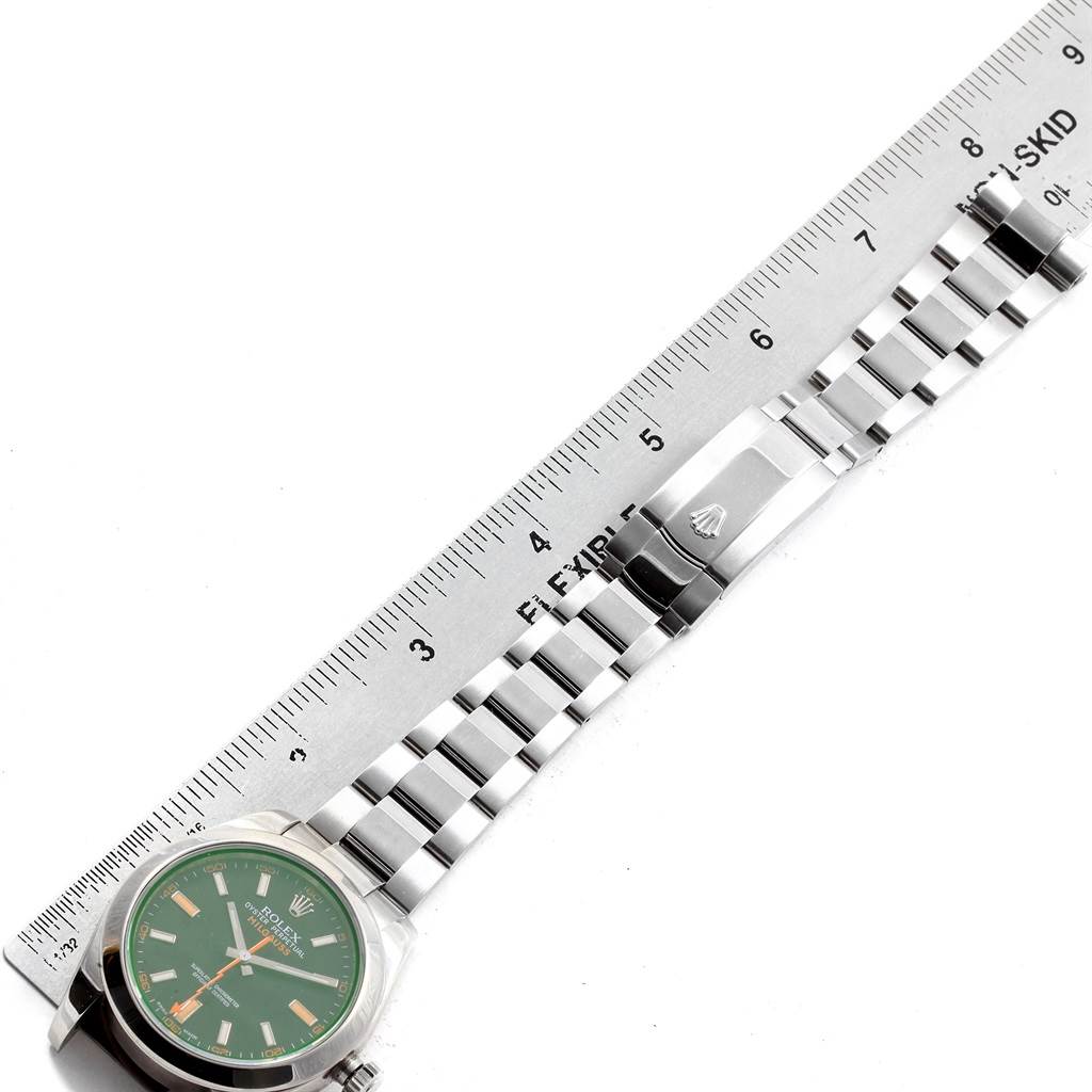 This image shows a flat view of the Rolex Milgauss 116400V Men's Stainless Steel Black Dial 116400V Men's Stainless Steel Black Dial watch, focusing on the face and stainless steel bracelet, next to a ruler.