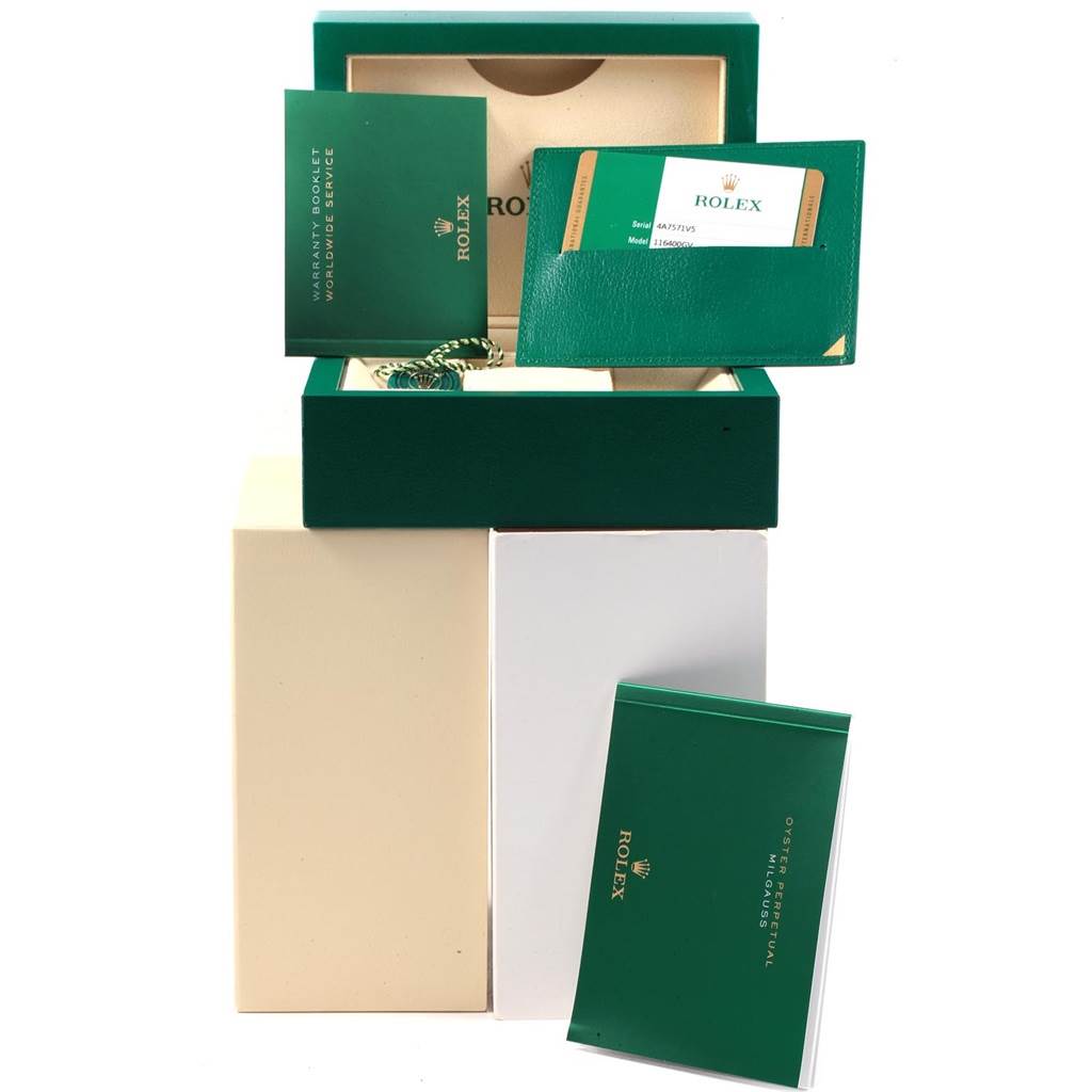 The image shows the box and accessories of a Rolex Milgauss 116400GV Men's Stainless Steel Blue Dial 116400GV Men's Stainless Steel Blue Dial watch, including booklets and a warranty card holder.