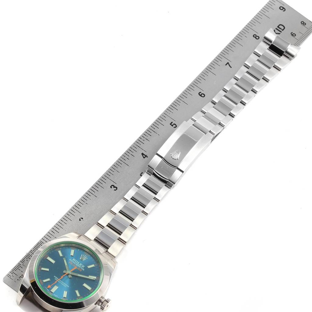 This image shows the Rolex Milgauss 116400V Men's Stainless Steel Blue Dial 116400V Men's Stainless Steel Blue Dial watch laid flat with its band extended alongside a ruler for measurement.
