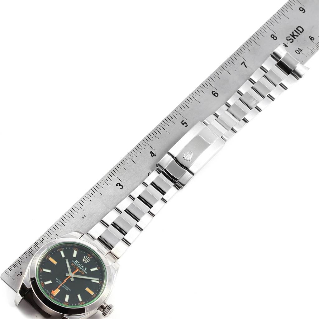 The image shows a Rolex Milgauss 116400V Men's Stainless Steel Black Dial 116400V Men's Stainless Steel Black Dial watch from an overhead angle with a ruler for scale, displaying the face and full bracelet.