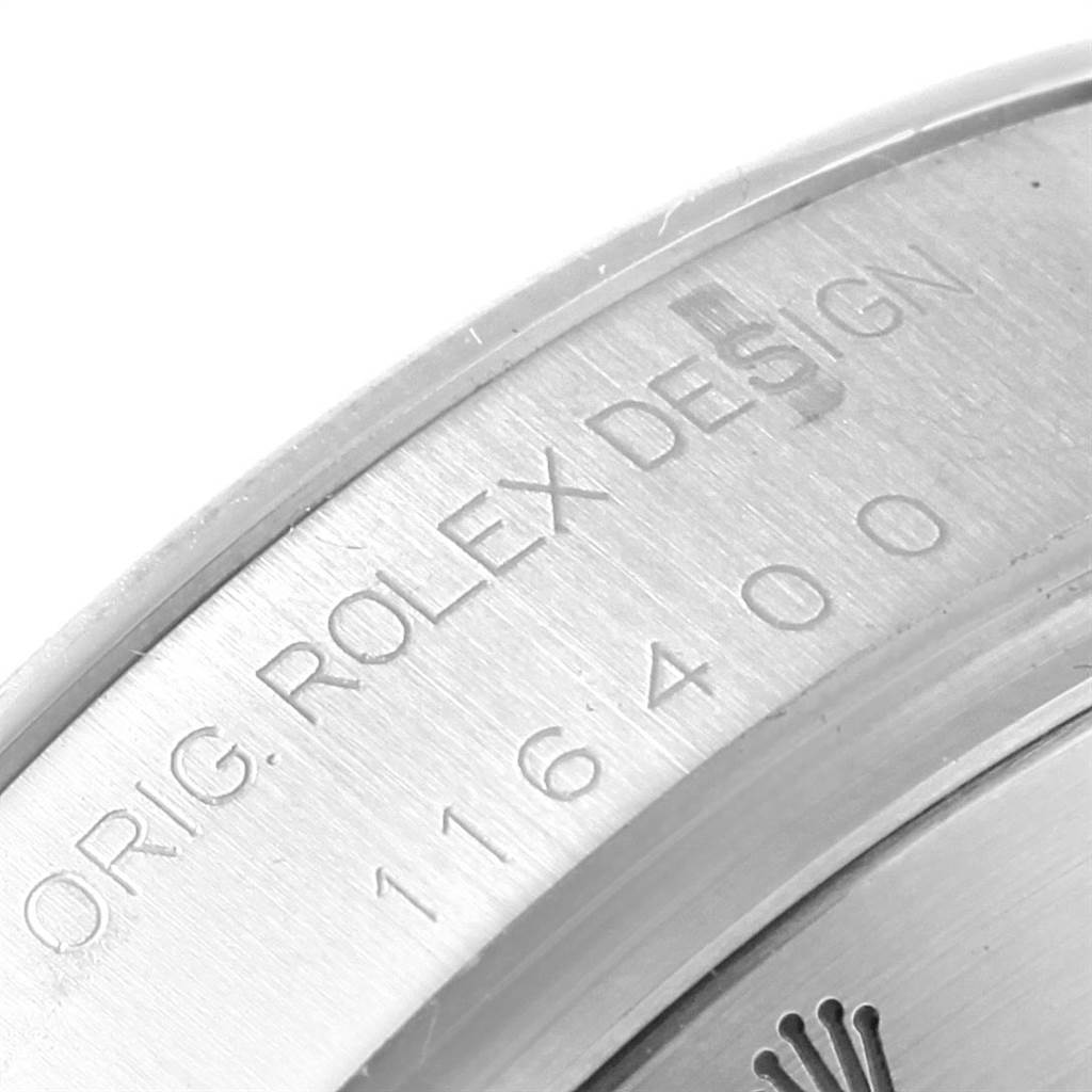 The image shows a close-up view of the Milgauss by Rolex, focusing on the serial number and branding on the outer casing.