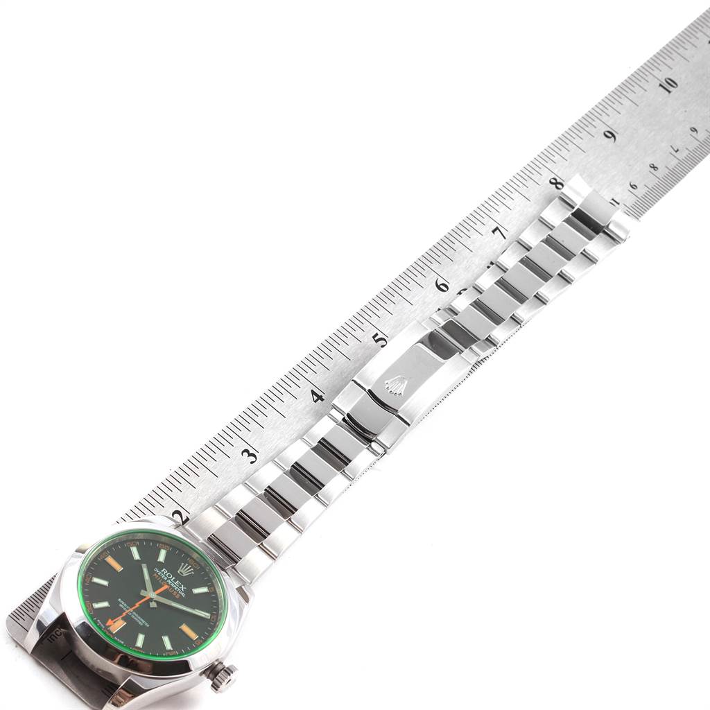 The image shows a Rolex Milgauss 116400V Men's Stainless Steel Black Dial 116400V Men's Stainless Steel Black Dial watch laid flat next to a ruler, displaying its face and bracelet.