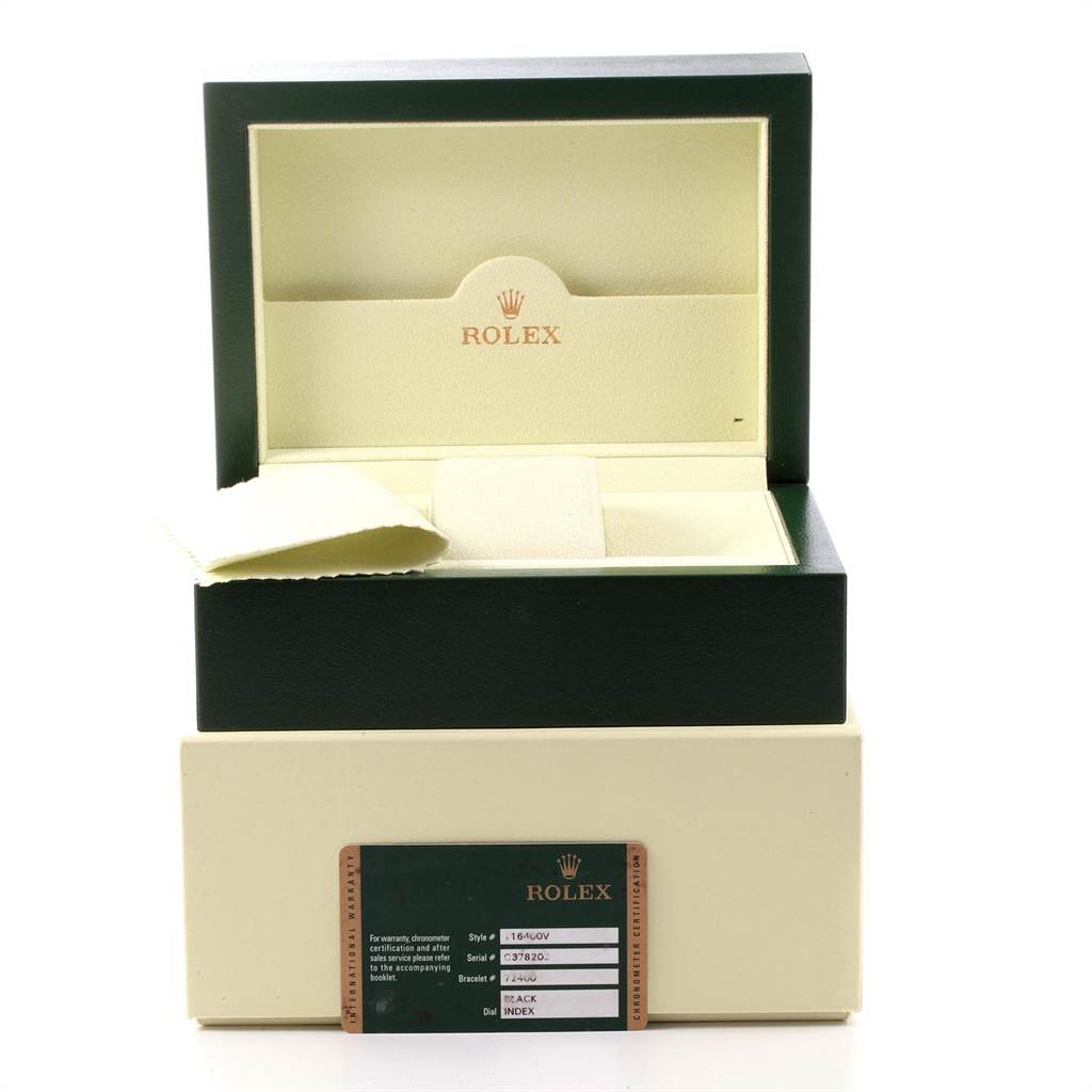 The image shows an open Rolex Milgauss 116400V Men's Stainless Steel Black Dial 116400V Men's Stainless Steel Black Dial watch box with a cleaning cloth and a warranty card displayed.