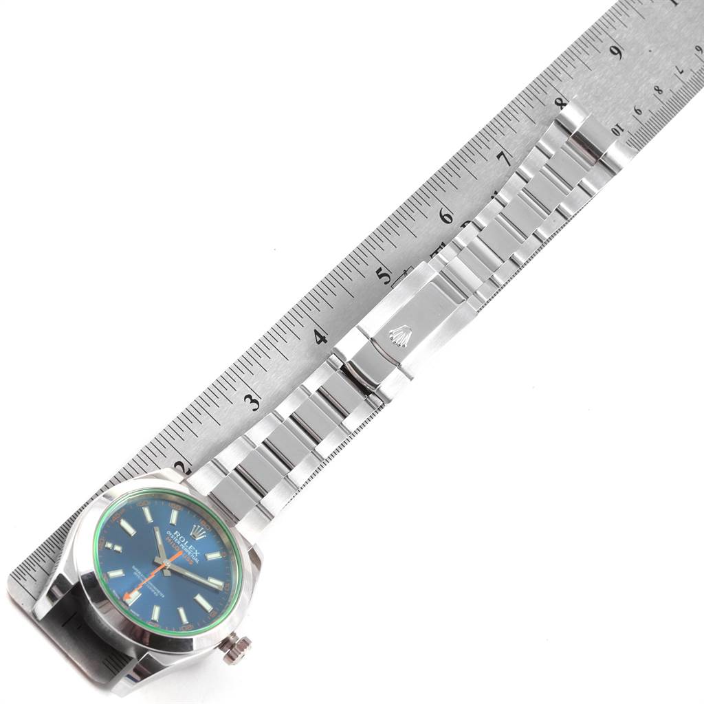 The image shows the Rolex Milgauss 116400GV Men's Stainless Steel Blue Dial 116400GV Men's Stainless Steel Blue Dial watch laid flat alongside a ruler, highlighting its bracelet and clasp.