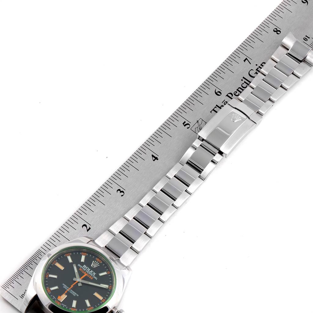 The image shows a Rolex Milgauss 116400V Men's Stainless Steel Black Dial 116400V Men's Stainless Steel Black Dial watch placed horizontally next to a ruler, highlighting the watch face and bracelet.