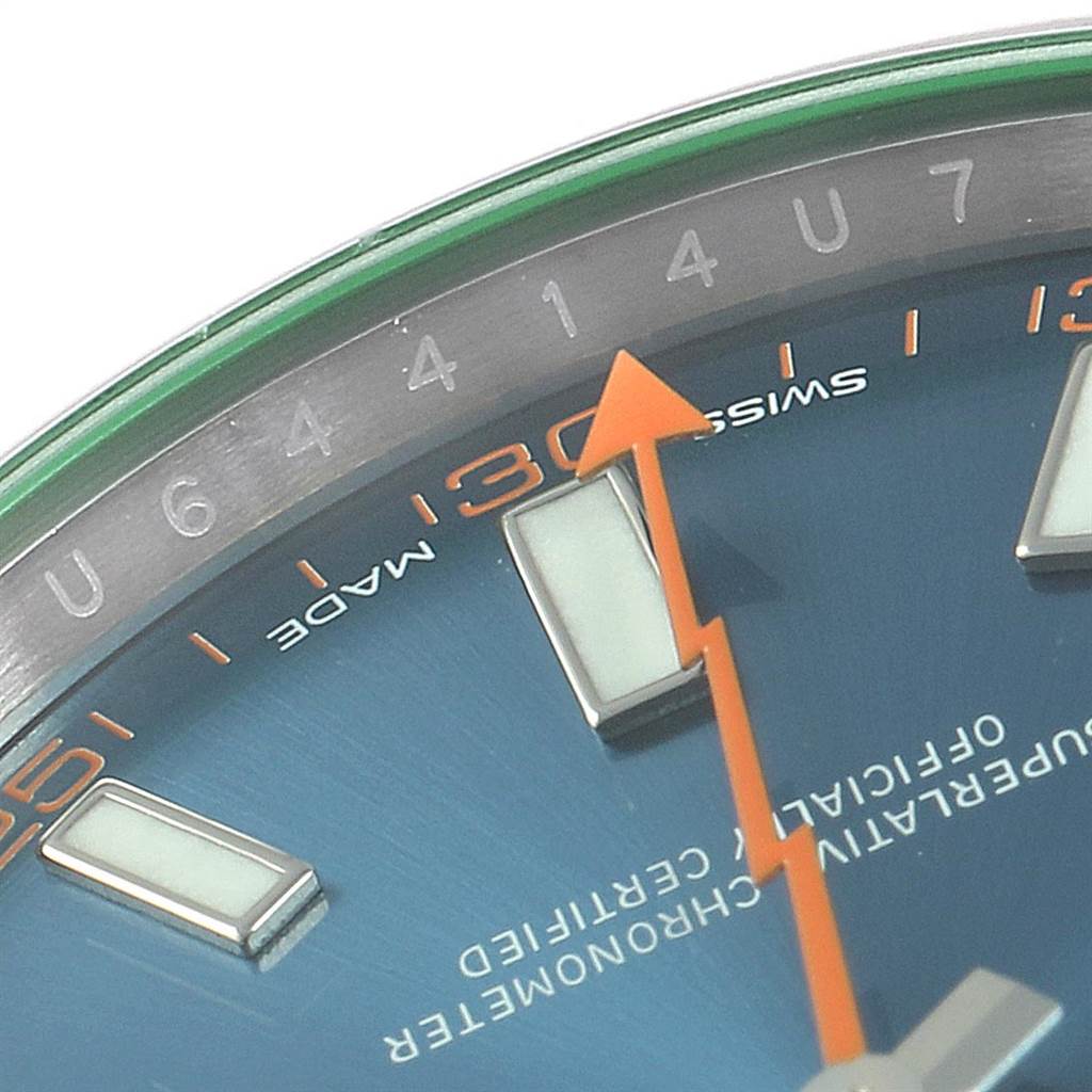 This close-up shot of a Rolex Milgauss 116400GV Men's Stainless Steel Blue Dial 116400GV Men's Stainless Steel Blue Dial watch shows part of the dial, hour markers, and the orange lightning-bolt second hand.