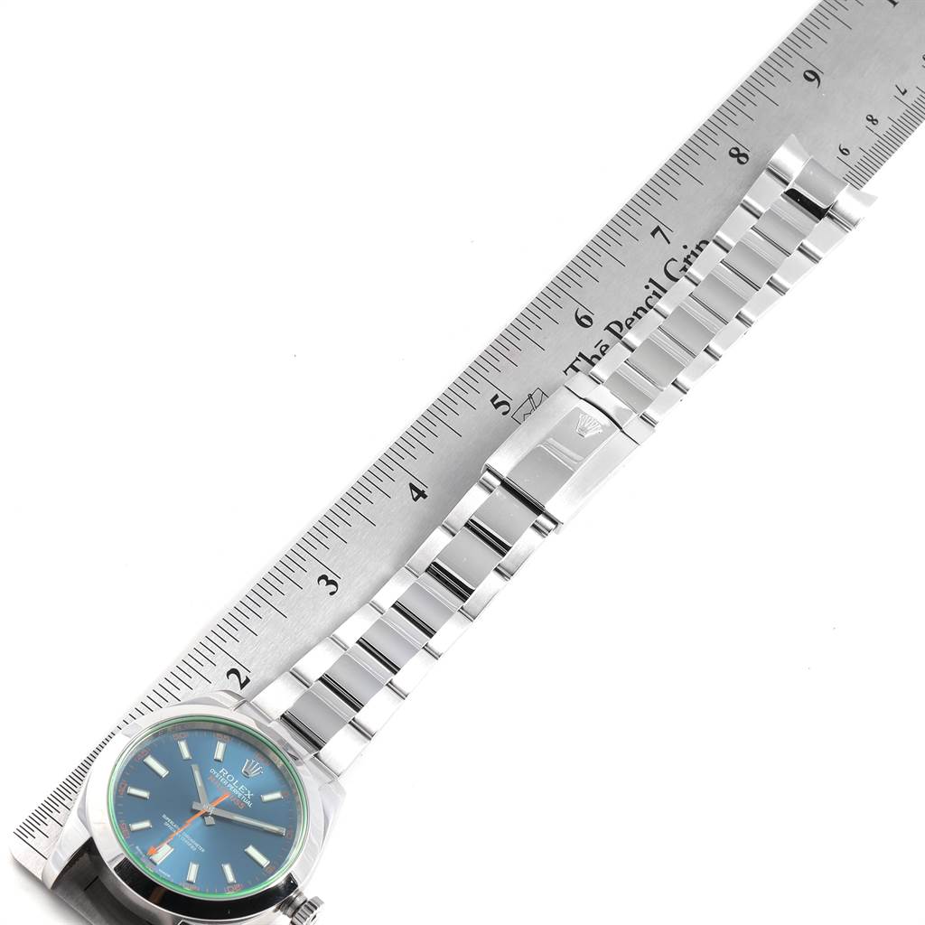 The image shows a Rolex Milgauss 116400GV Men's Stainless Steel Blue Dial 116400GV Men's Stainless Steel Blue Dial watch laid flat next to a ruler, displaying its face, bracelet, and clasp.